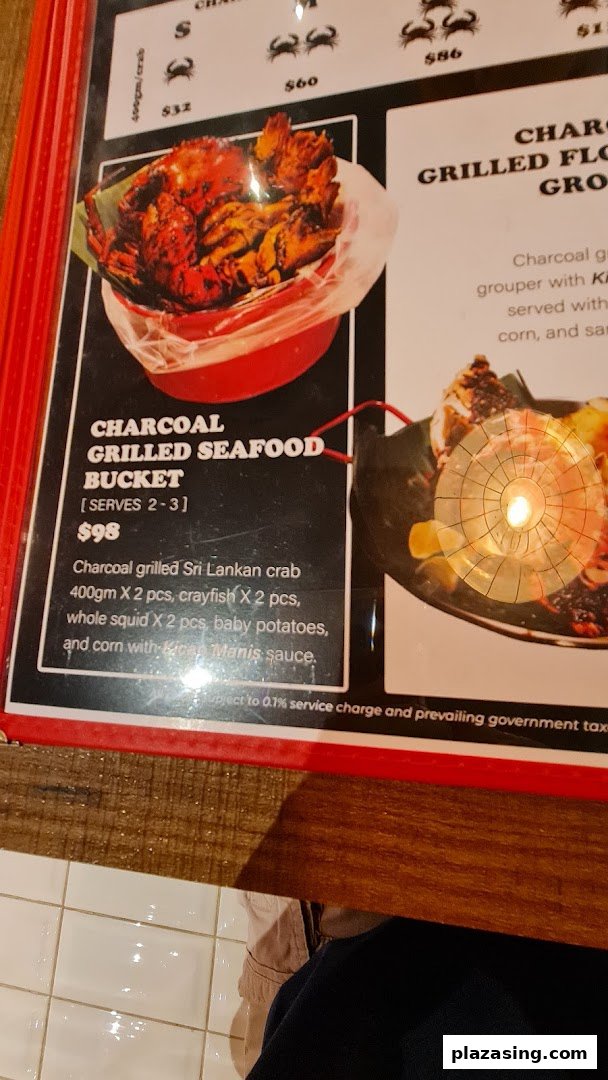A menu page displaying a charcoal grilled seafood bucket and crab options with prices.