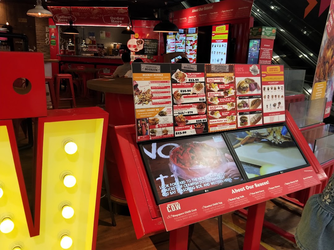 A vibrant menu display at Cajun on Wheels, showcasing seafood buckets, platters, and sauces.