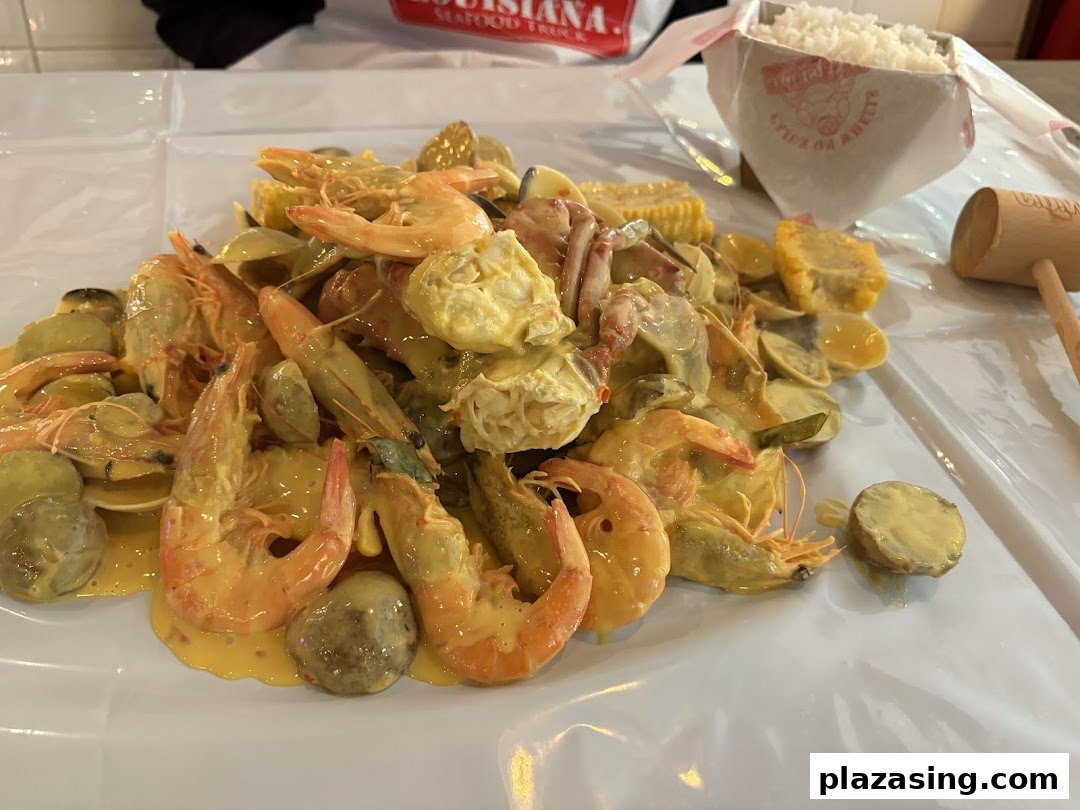 A vibrant close-up of a Cajun seafood boil with shrimp, clams, corn, and potatoes.