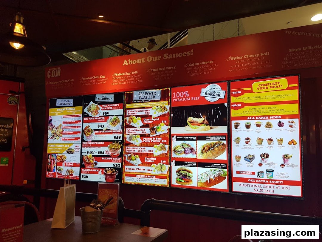 A vibrant digital menu board showcasing Cajun on Wheels' seafood buckets, platters, burgers, and sides.