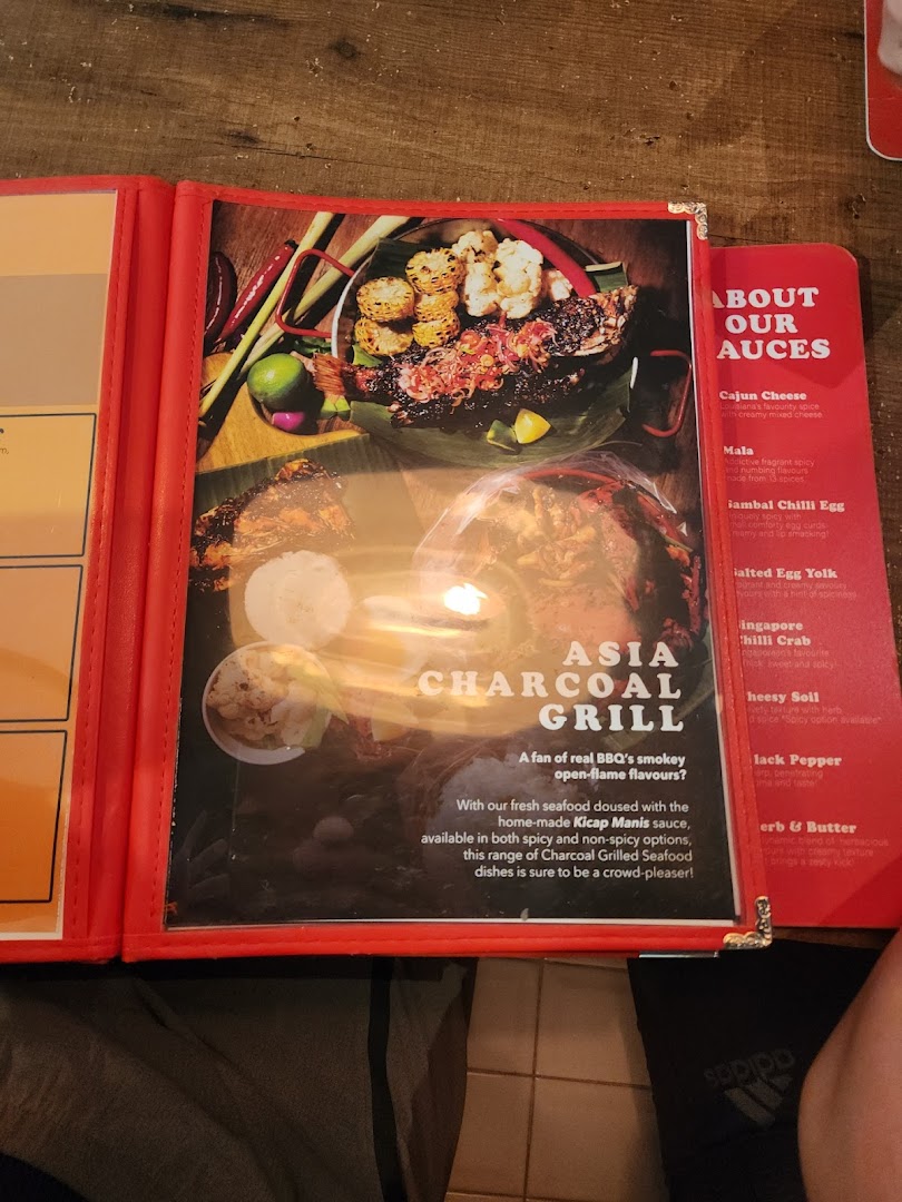 A menu page showcasing charcoal-grilled seafood and available sauces.