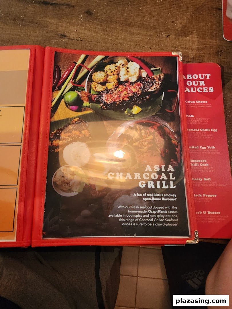 A menu page showcasing charcoal-grilled seafood and available sauces.