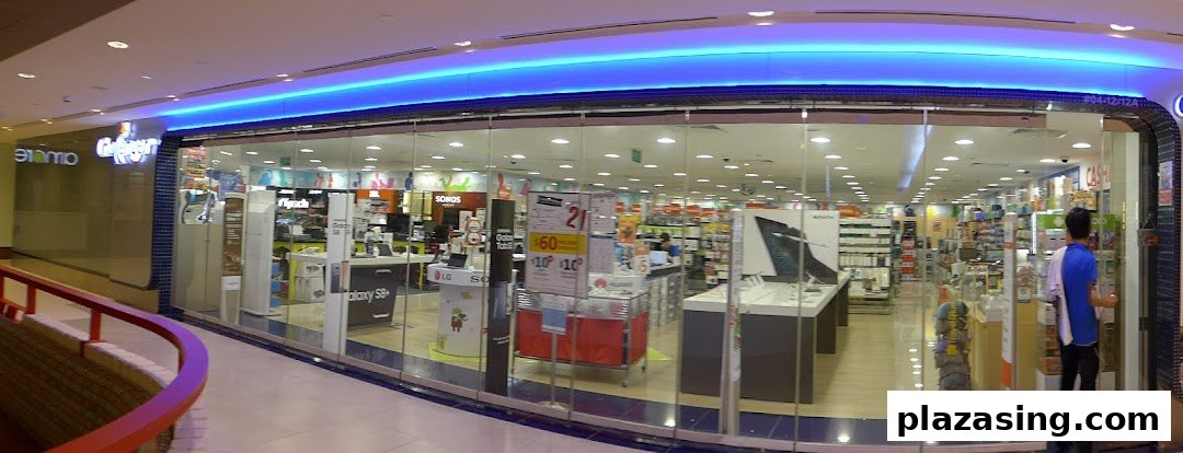 Brightly lit entrance of Challenger, an electronics store, showcasing various tech products and displays.