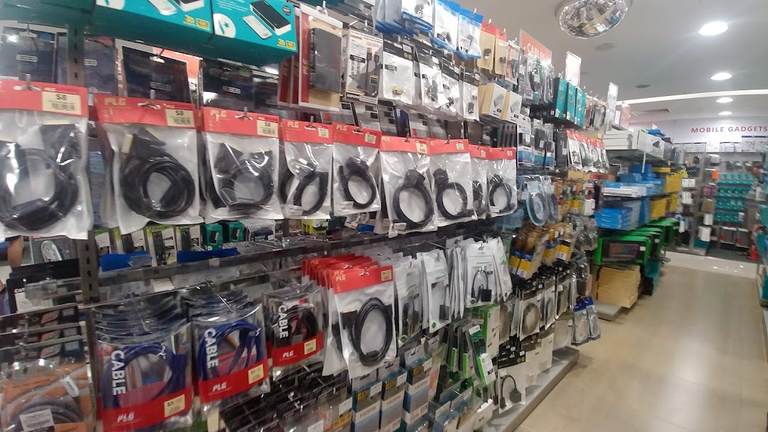 Shelves filled with various electronic cables, adapters, and mobile accessories inside Challenger Plaza Singapura.