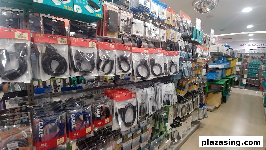 Shelves filled with various electronic cables, adapters, and mobile accessories inside Challenger Plaza Singapura.