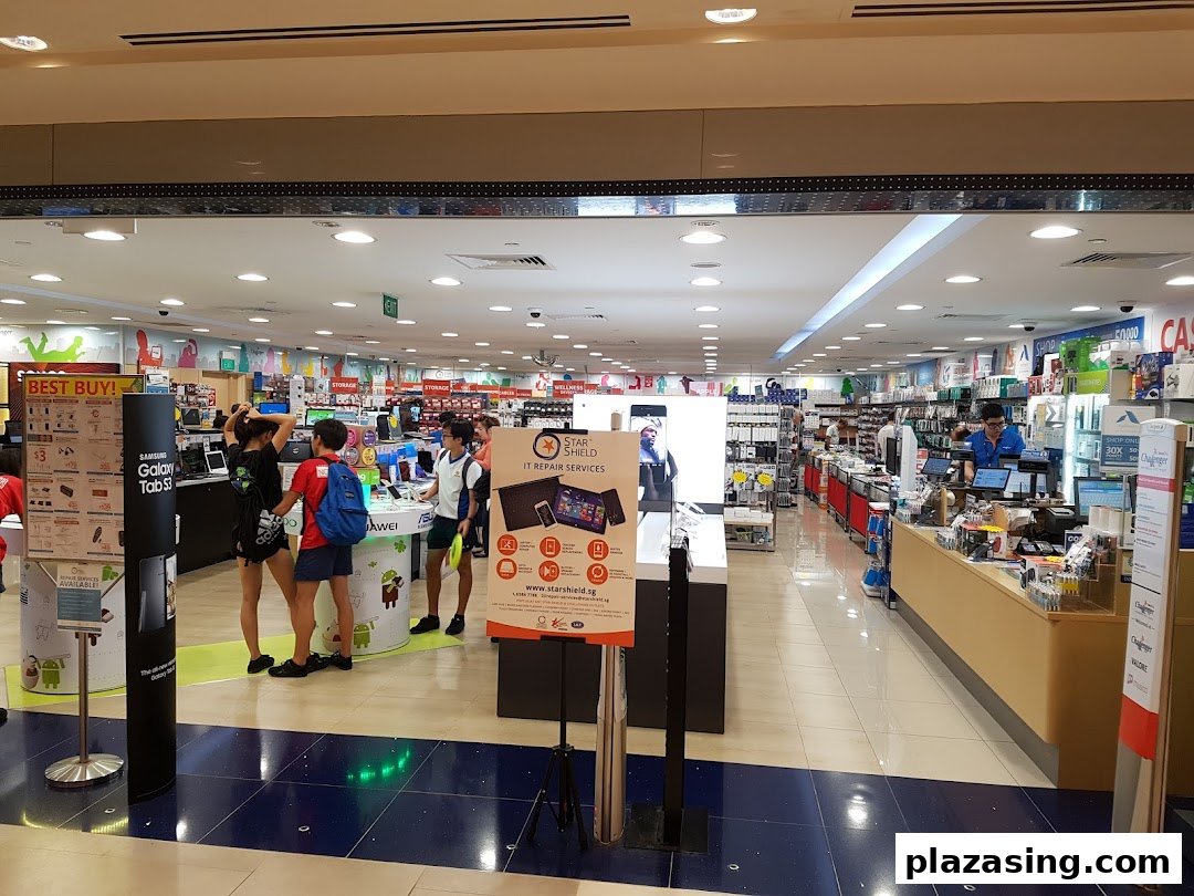 Interior view of Challenger, an electronics store, with customers browsing various tech products and displays.