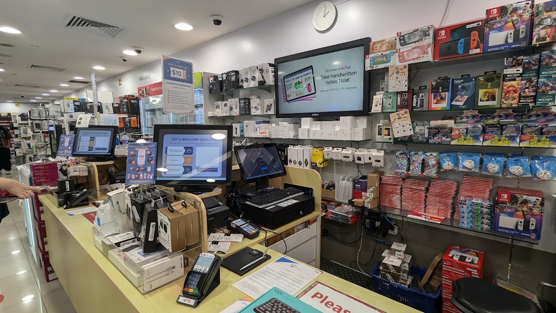 Interior view of an electronics store showcasing various gadgets, accessories, and gaming consoles.