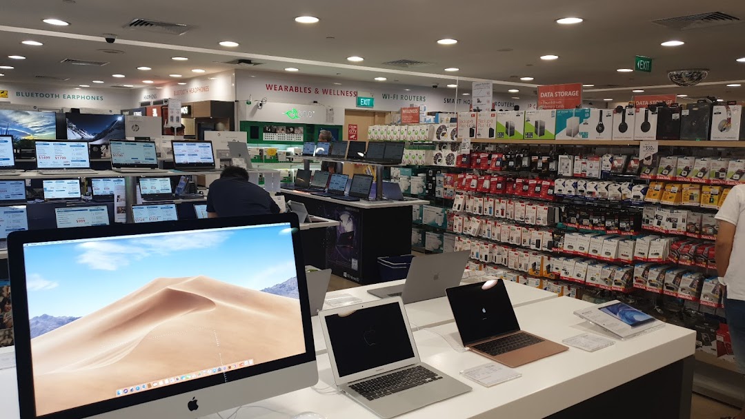 Interior view of Challenger electronics store showcasing laptops, accessories, and various tech products.