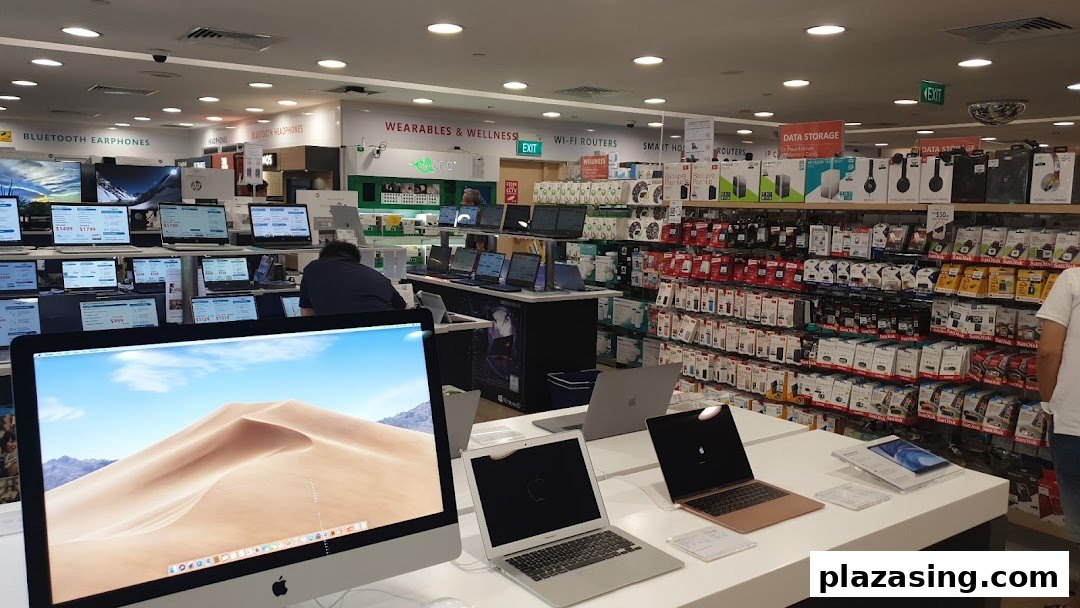 Interior view of Challenger electronics store showcasing laptops, accessories, and various tech products.
