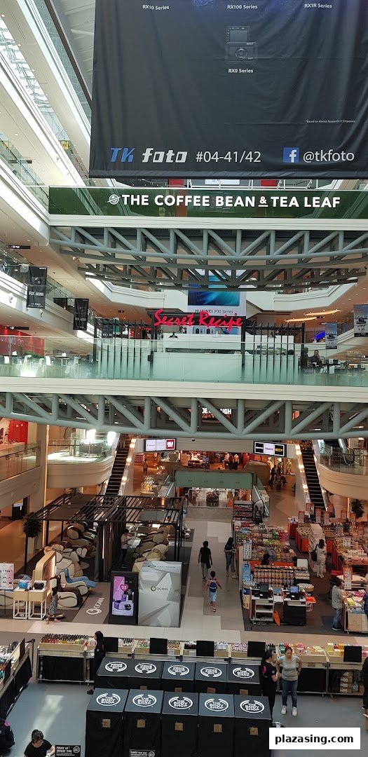 A vibrant multi-level view of a shopping mall interior, showcasing various retail and F&B outlets.