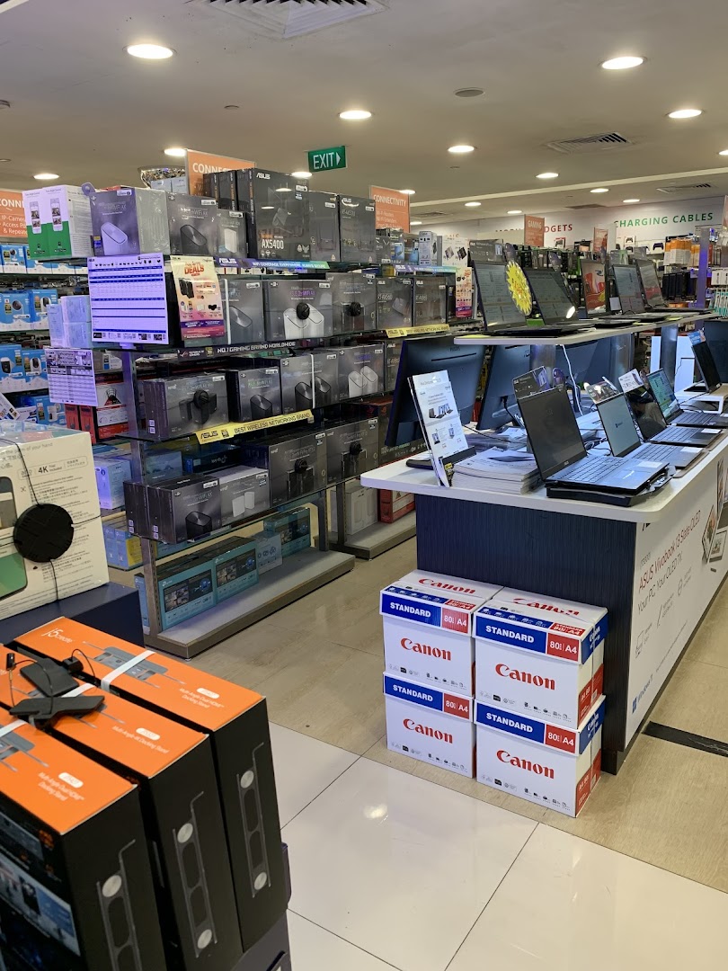 Interior view of Challenger electronics store showcasing laptops, networking gear, and computer accessories.