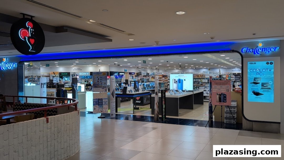 The brightly lit entrance of Challenger, an electronics and IT retail store, showcasing various tech products.