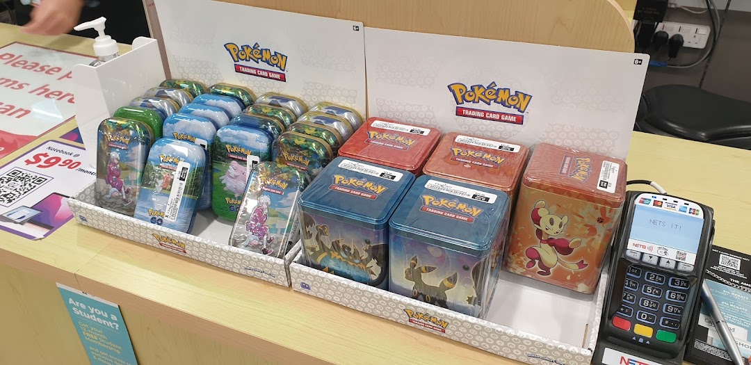 A vibrant display of various Pokémon Trading Card Game tins and boxes at Challenger Plaza Singapura.