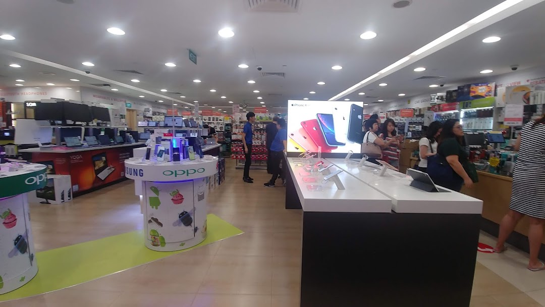 Interior view of Challenger electronics store, showcasing various tech products, displays, and customers browsing.