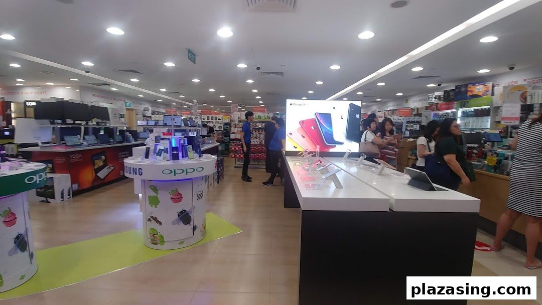 Interior view of Challenger electronics store, showcasing various tech products, displays, and customers browsing.