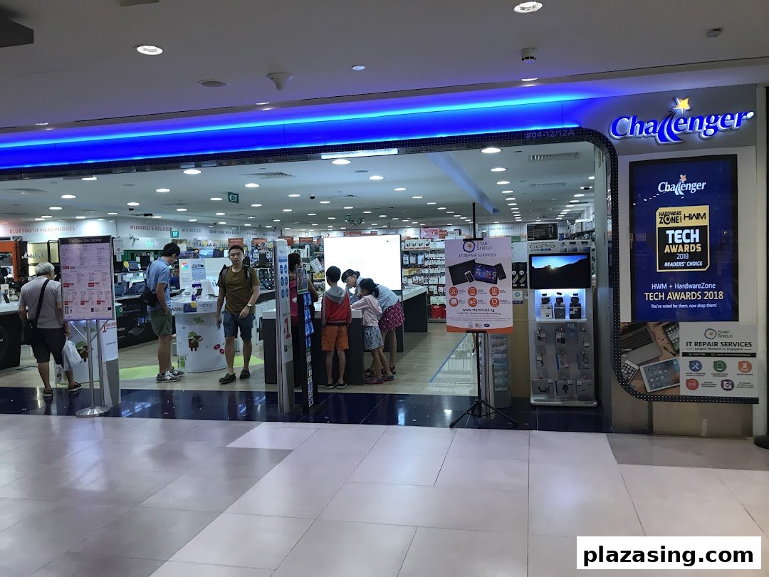 Entrance of Challenger electronics store with customers browsing and promotional displays.