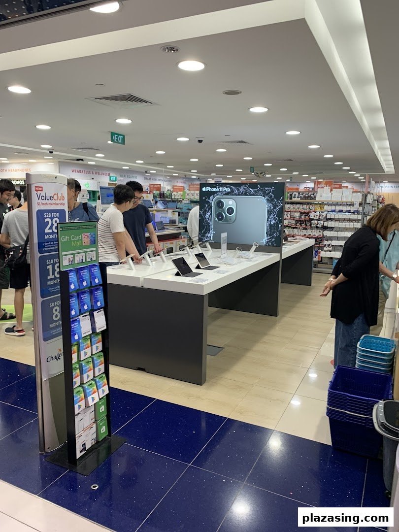 Customers browse electronics, including an iPhone 11 Pro display, at Challenger Plaza Singapura.