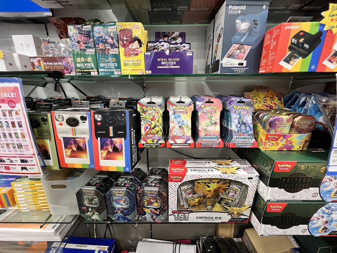 Shelves displaying Polaroid cameras, Pokémon trading cards, and One Piece card games at Challenger.