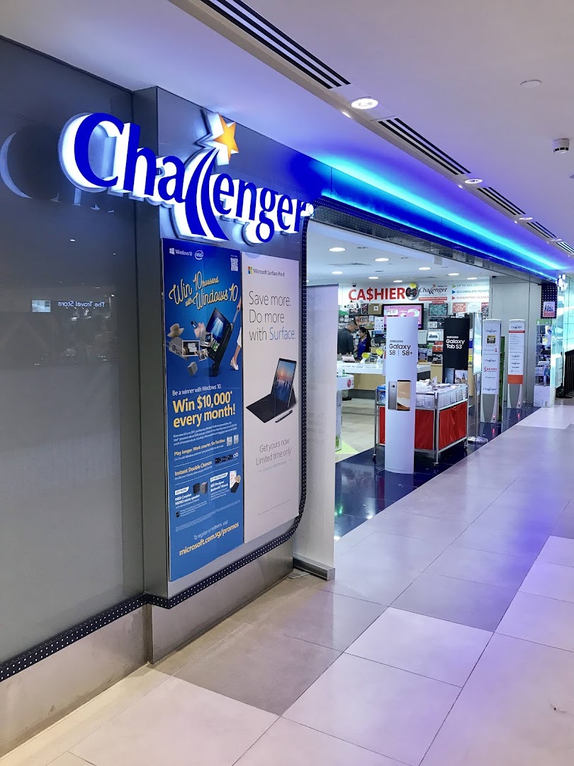 The brightly lit entrance of Challenger Plaza Singapura, showcasing its prominent blue and white signage and promotional displays.