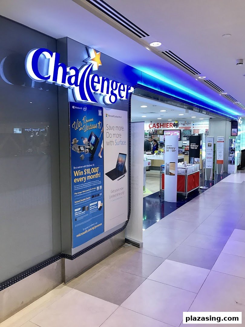 The brightly lit entrance of Challenger Plaza Singapura, showcasing its prominent blue and white signage and promotional displays.