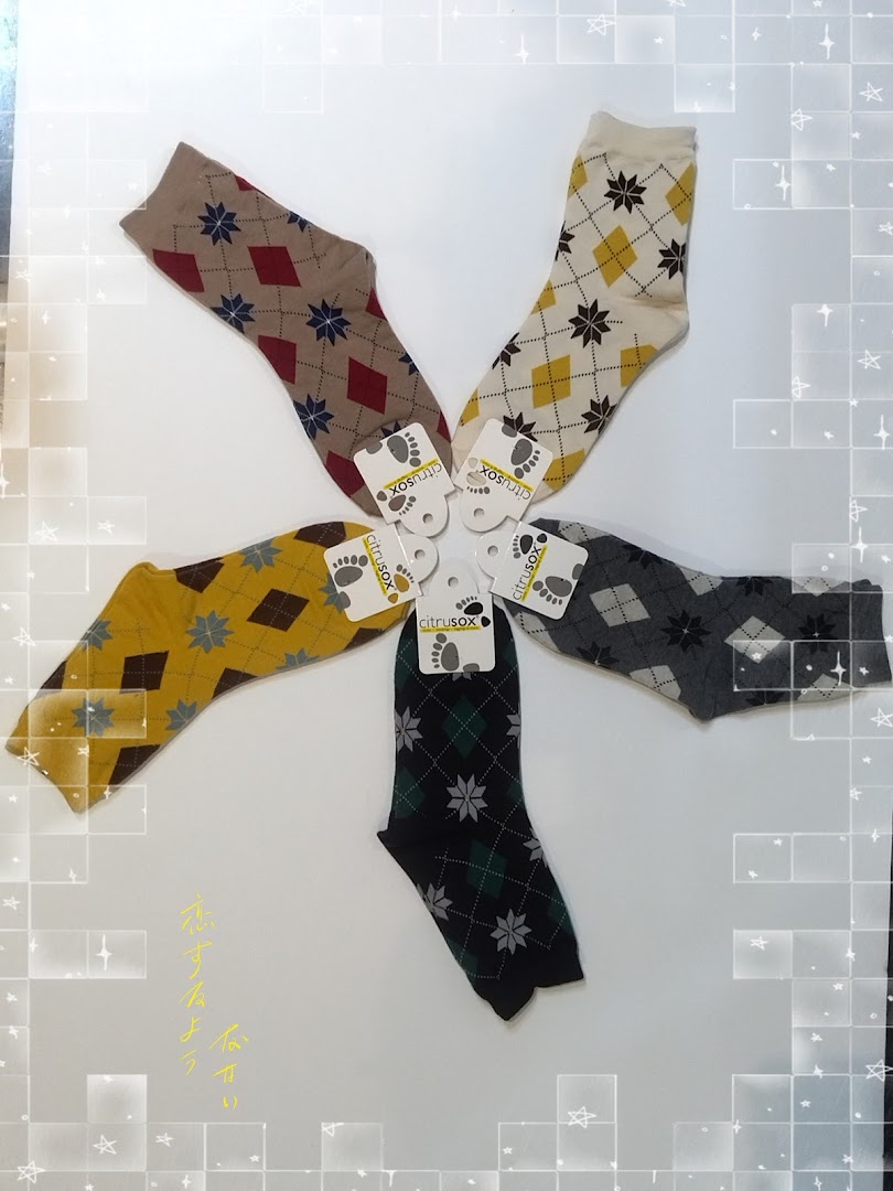 An array of colorful argyle-patterned socks from Citrusox, arranged in a circular display.