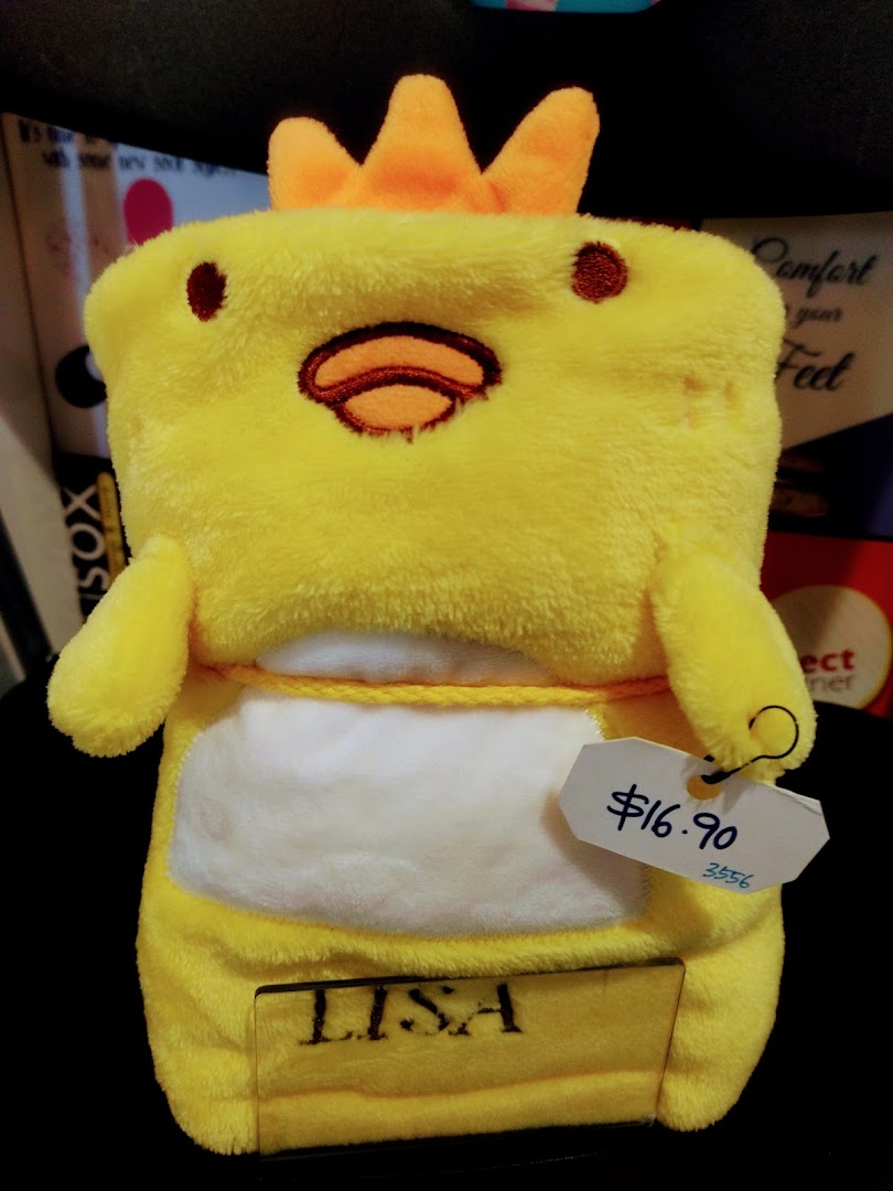A yellow chick-shaped plush item with a price tag of $16.90, possibly a blanket or pillow.