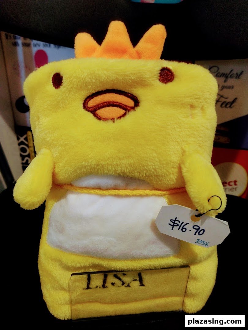 A yellow chick-shaped plush item with a price tag of $16.90, possibly a blanket or pillow.
