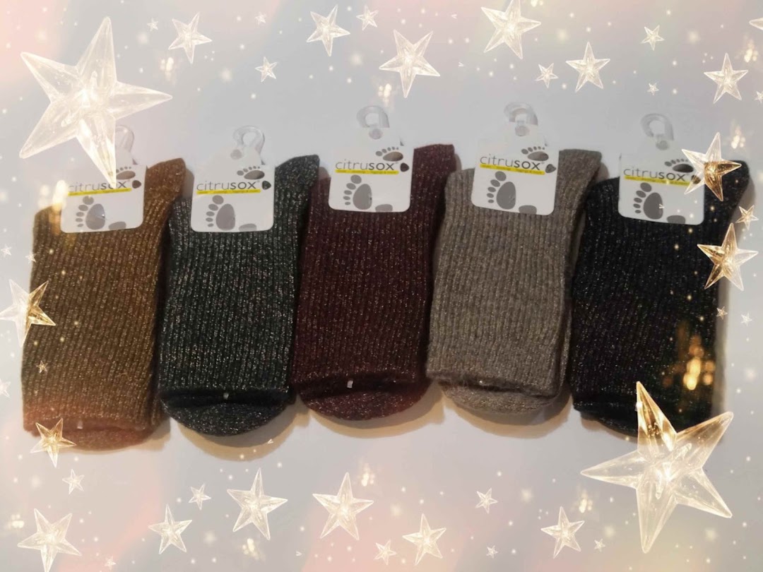 A row of five Citrusox socks in various shimmering colors, displayed with star overlays.
