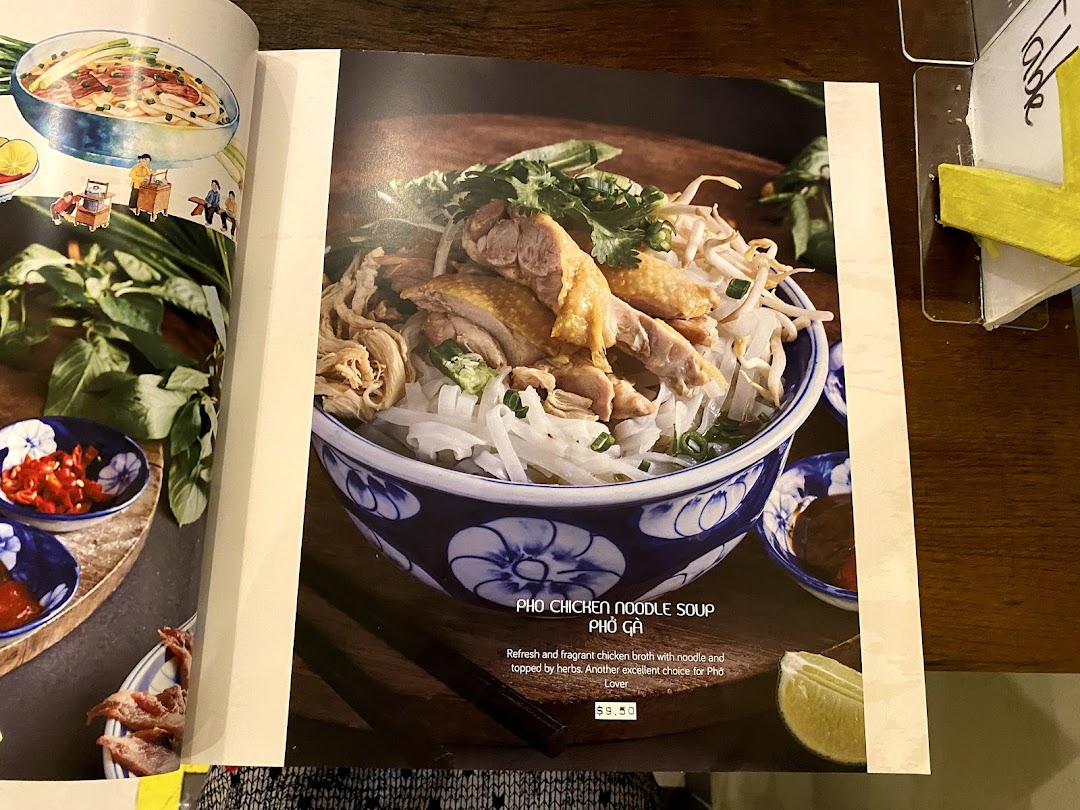 A menu page displaying a vibrant image of Pho Chicken Noodle Soup with its description and price.