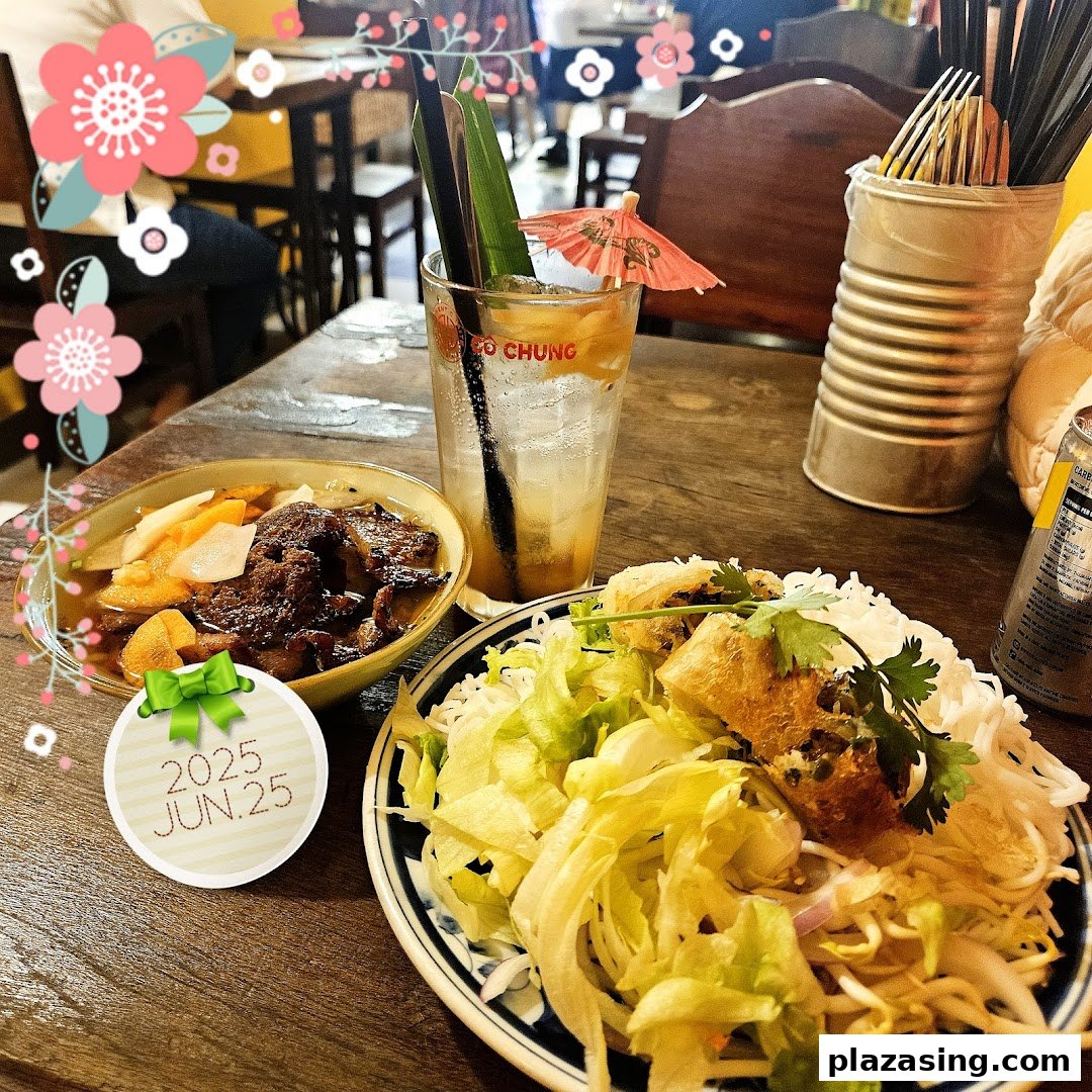 A table laden with authentic Vietnamese dishes, including Bun Cha and vermicelli noodles, alongside a refreshing drink.