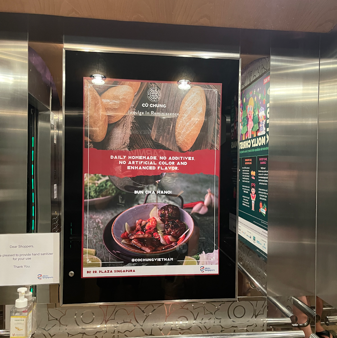 An advertisement for Co Chung Vietnamese Restaurant featuring Bun Cha Hanoi and baguettes, highlighting homemade quality.