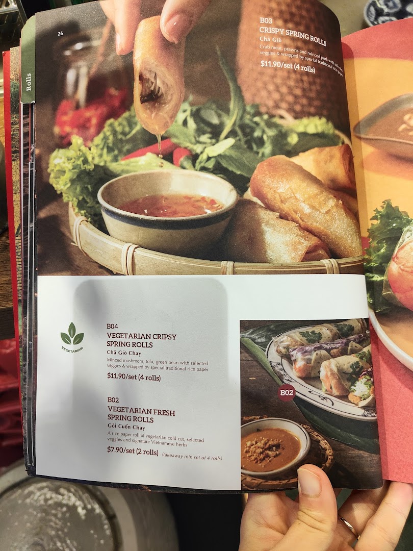 A close-up of Co Chung's menu page featuring various Vietnamese spring rolls.
