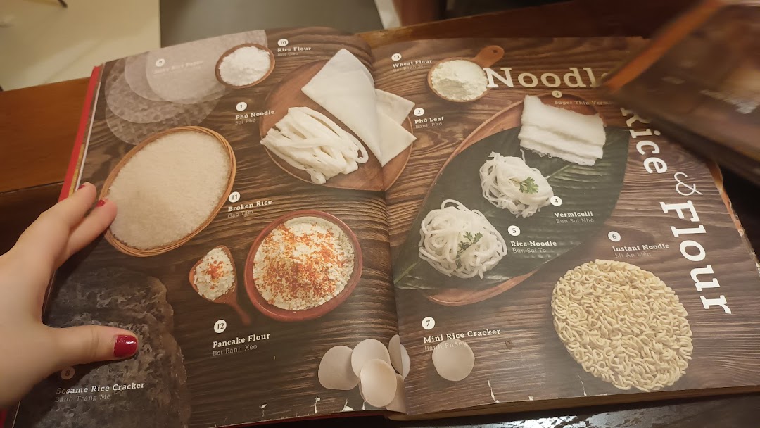 An open menu page from Co Chung Vietnamese Restaurant, showcasing various rice, flour, and noodle ingredients.