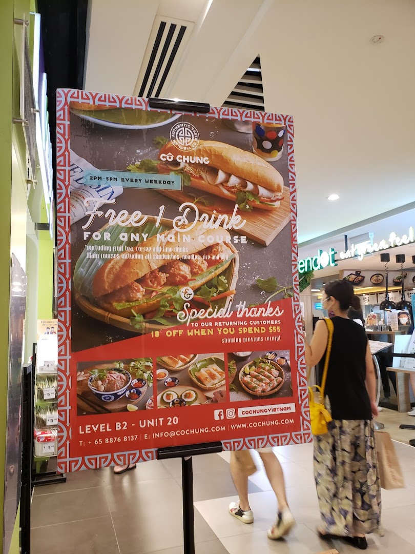 A promotional standee for Co Chung Vietnamese Restaurant showcasing food items and special offers.