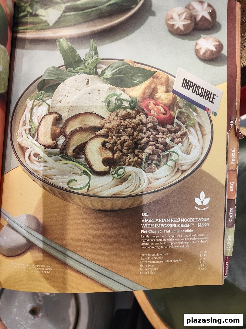 A menu page displaying a vegetarian pho noodle soup with Impossible Beef and its add-ons.