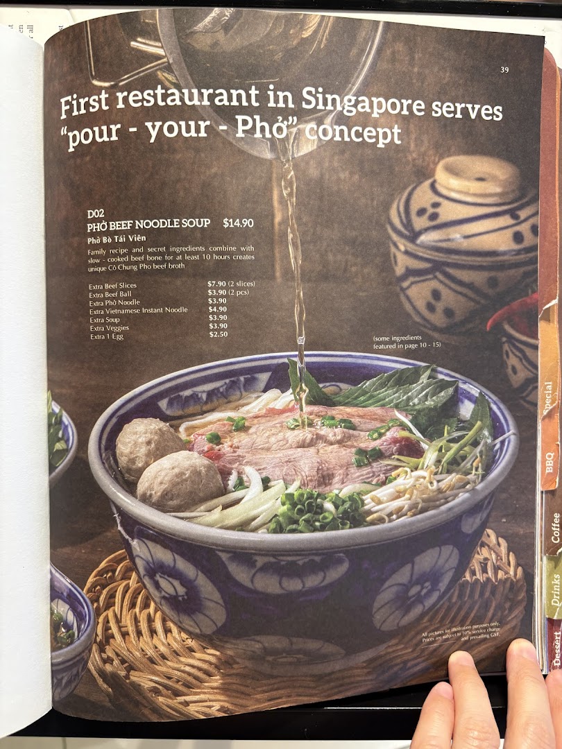 A menu page featuring a 'pour-your-own' Pho beef noodle soup with detailed descriptions and add-on prices.