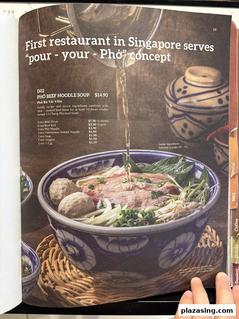 A menu page featuring a 'pour-your-own' Pho beef noodle soup with detailed descriptions and add-on prices.