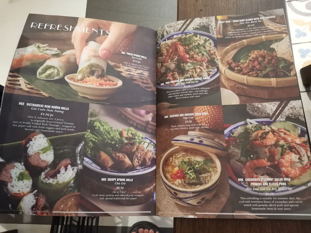 A Vietnamese restaurant menu showcasing appetizers, salads, and soups with descriptions and prices.