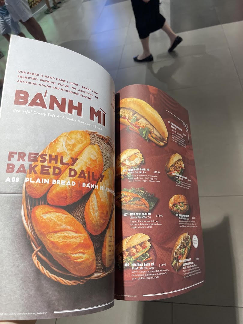 An open menu displaying various authentic Vietnamese Bánh Mì options with descriptions and prices.