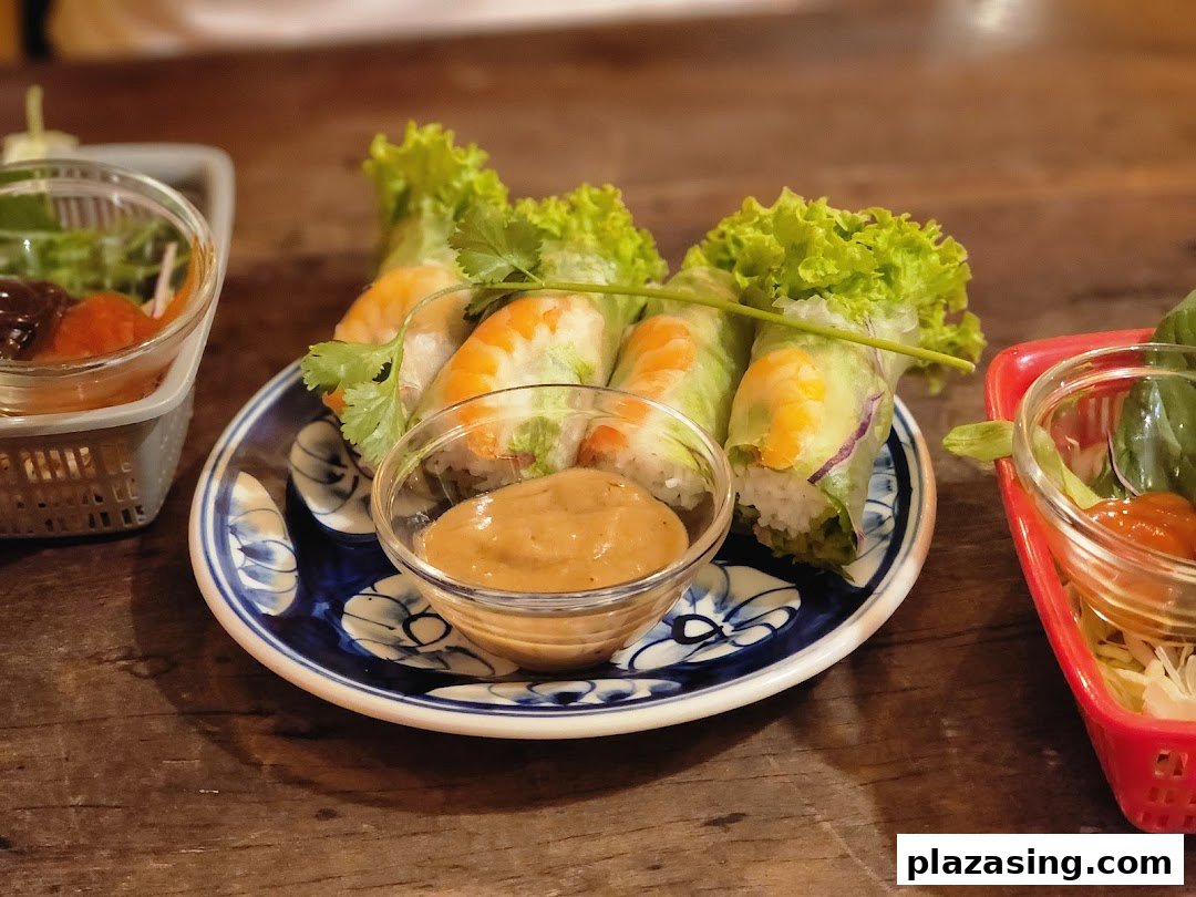 Fresh Vietnamese spring rolls with shrimp and vegetables, served with a rich peanut dipping sauce.