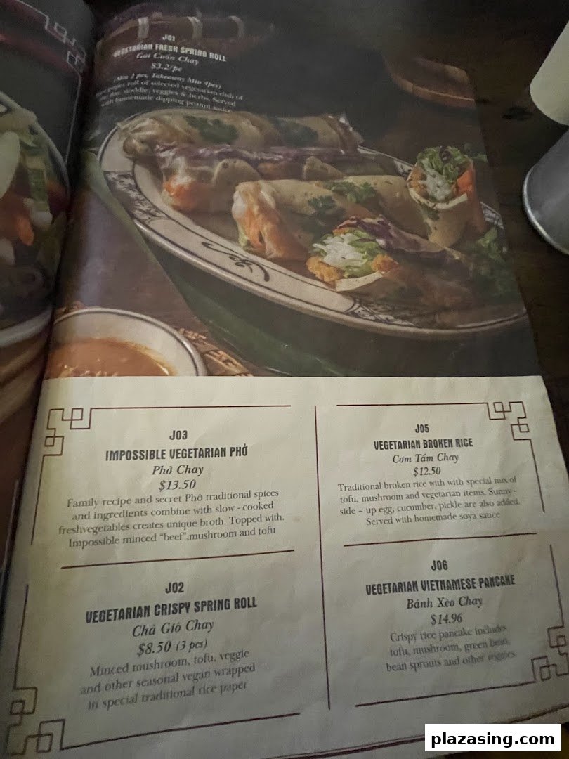 A close-up view of a Vietnamese restaurant menu featuring various vegetarian dishes with descriptions and prices.