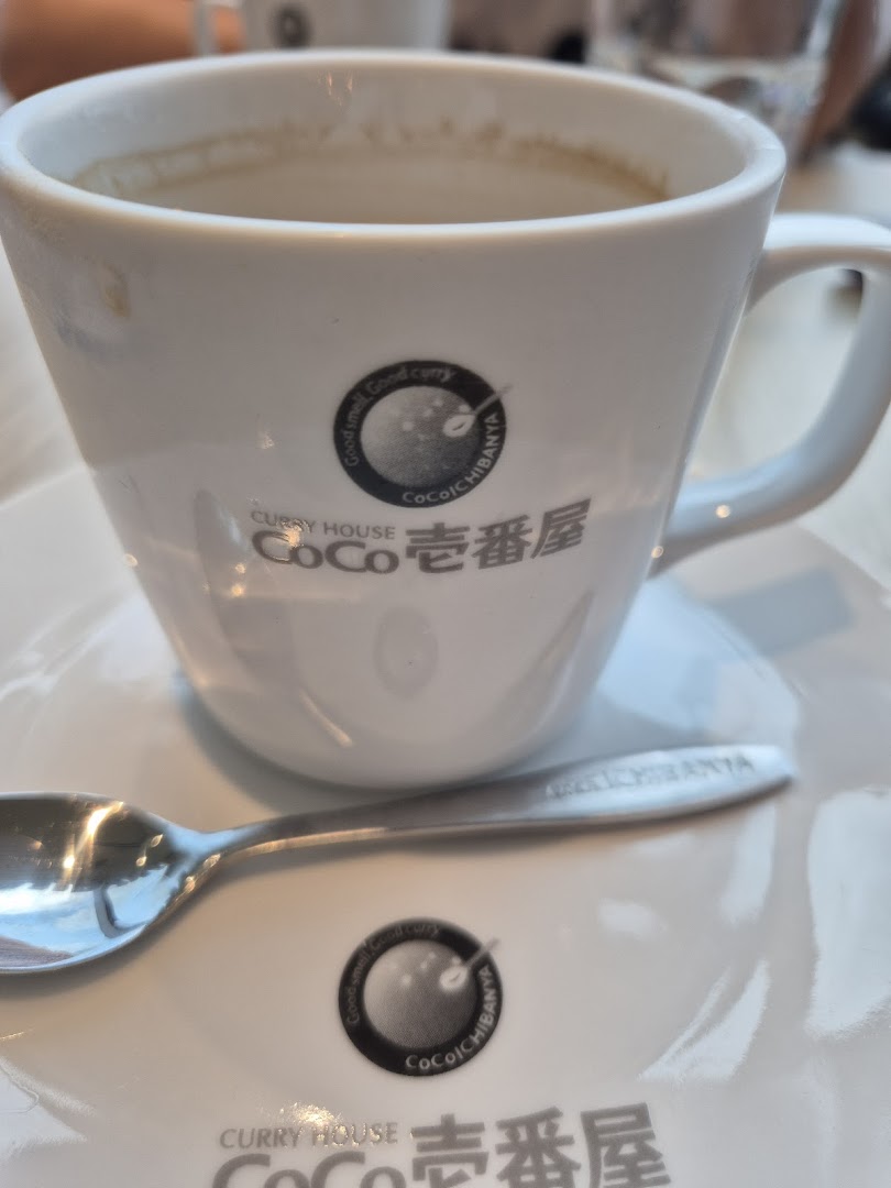 A white cup and spoon featuring the CoCo ICHIBANYA logo on a saucer.