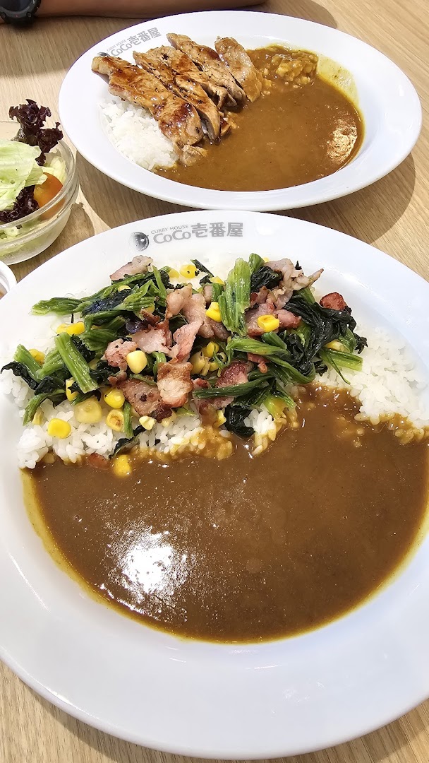 Delicious Japanese curry rice dishes with various toppings and a side salad from CoCo ICHIBANYA.