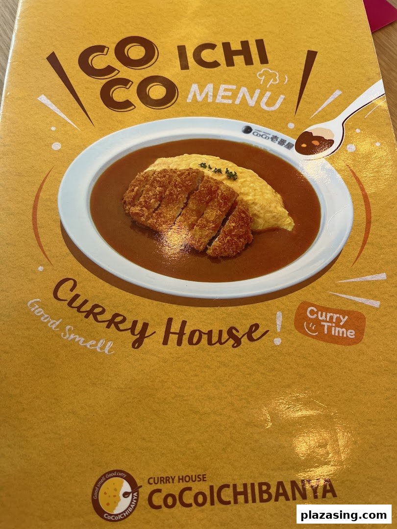 The vibrant cover of CoCo ICHIBANYA's menu, showcasing a delicious katsu curry dish.