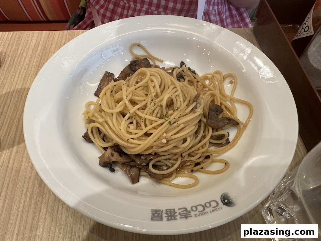 A close-up of a plate of spaghetti with mushrooms and garlic from CoCo ICHIBANYA.