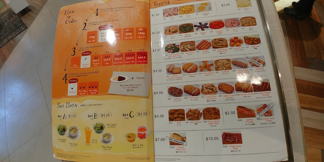 A detailed menu displaying curry customization options, various toppings, and set meals.