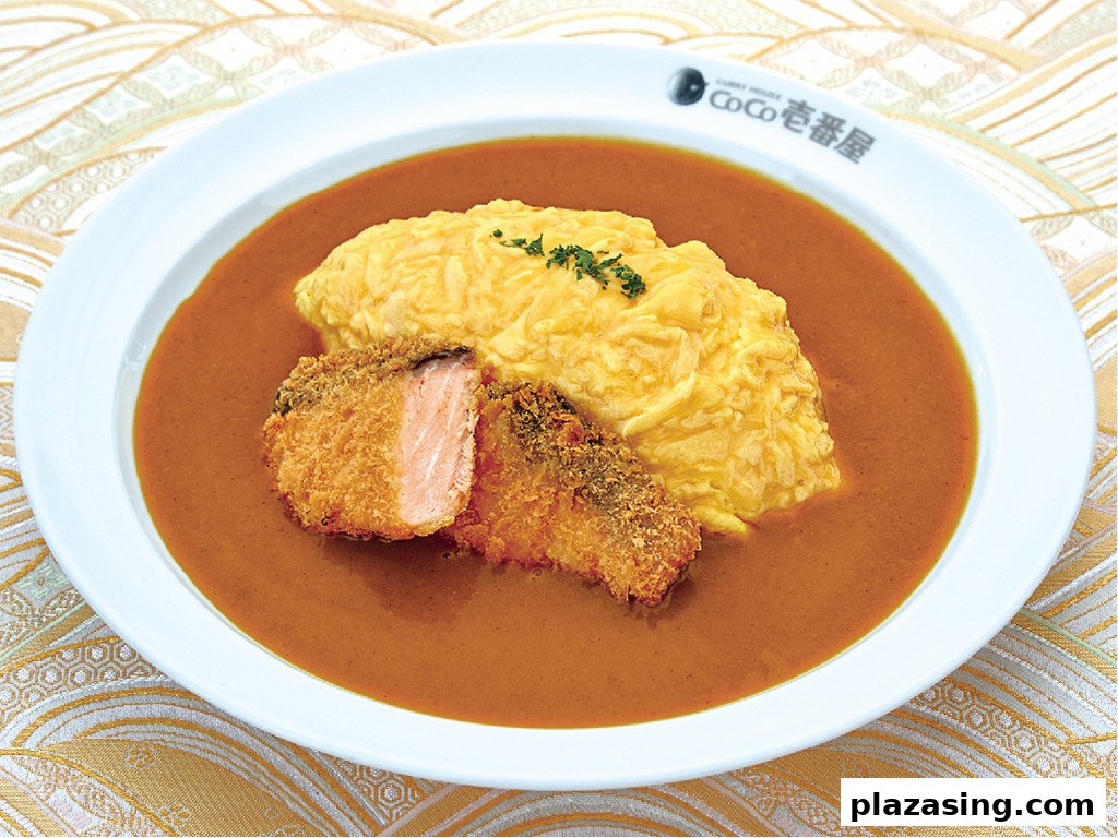 A plate of CoCo ICHIBANYA's curry with fluffy omelet and crispy fried salmon.