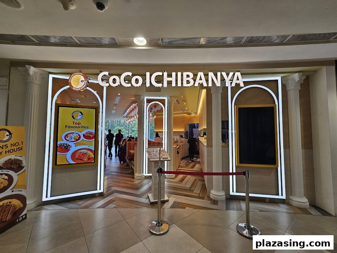 The brightly lit entrance of CoCo ICHIBANYA, a Japanese curry restaurant, with promotional displays.