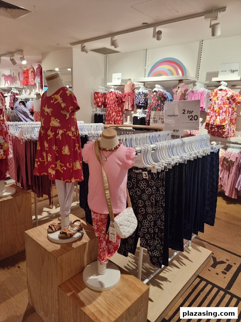 Colorful children's clothing displayed on mannequins and racks inside Cotton On Kids.