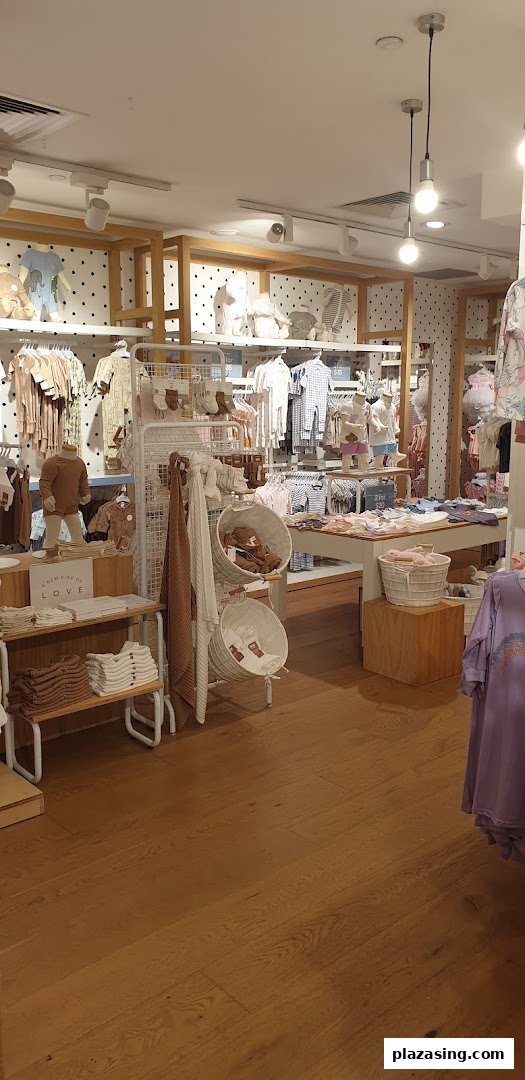 An interior view of Cotton On Kids, showcasing a wide array of baby and children's clothing and accessories.